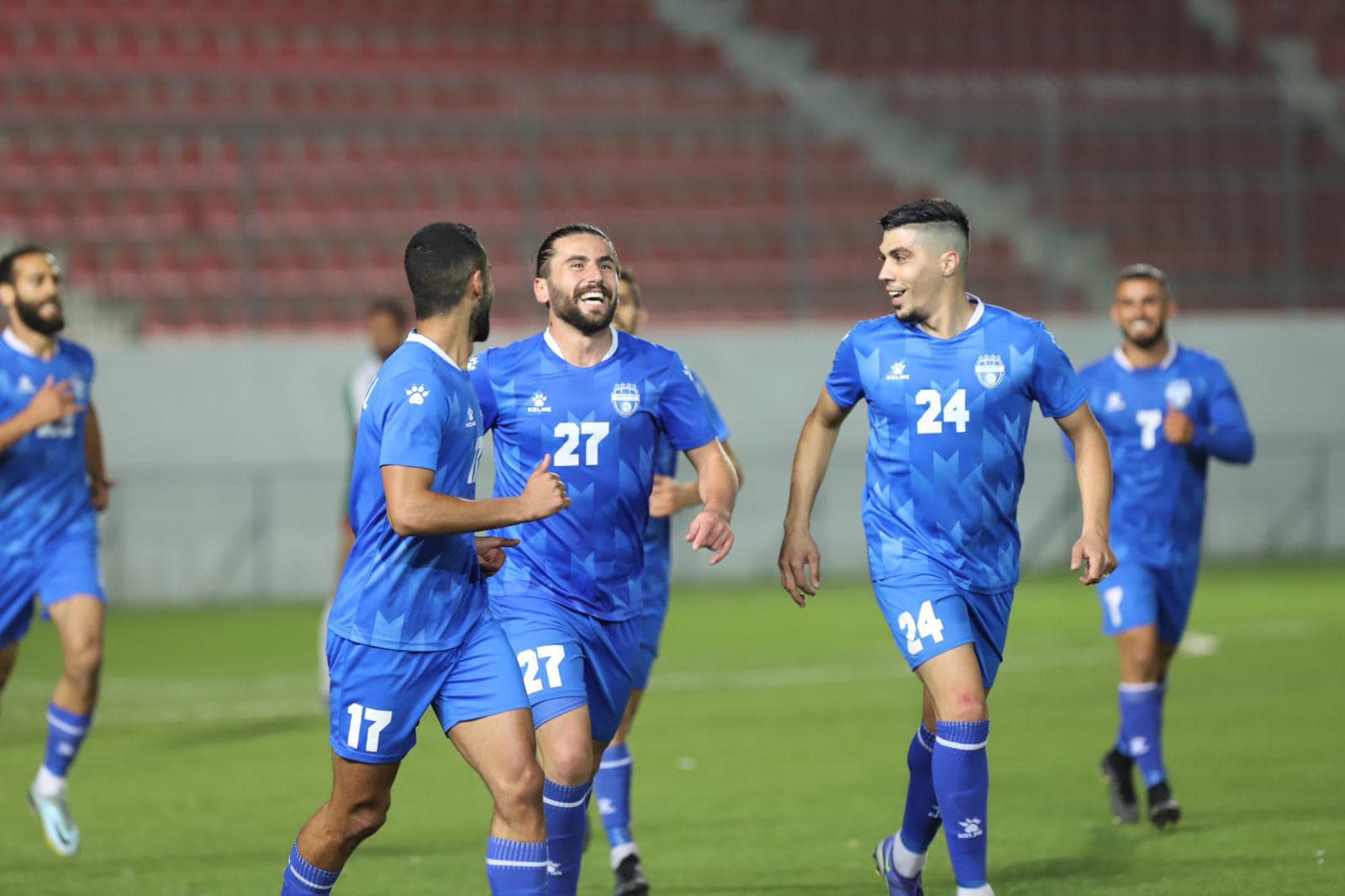 لاعبو "هلال القدس" يحتفلون بتسجيل هدف في شباك "الأمعري" في المباراة التي جمعتهما على استاد الشهيد فيصل الحسيني في بلدة الرام 