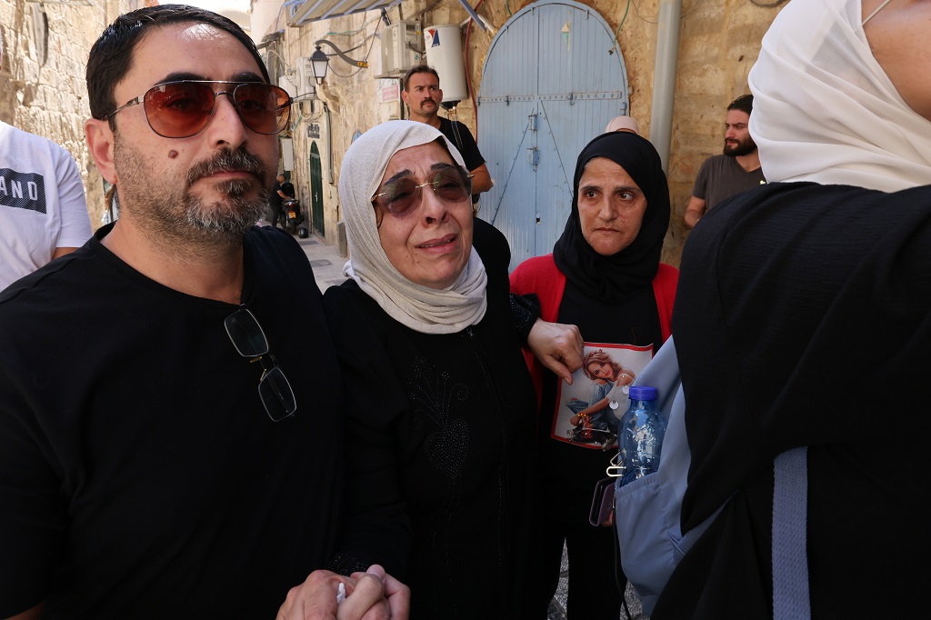 نورا غيث صب لبن ونجلها أحمد عقب إخلاء العائلة القسري من بيتها في القدس المحتلة لصالح المستوطنين (تصوير: أ ف ب)