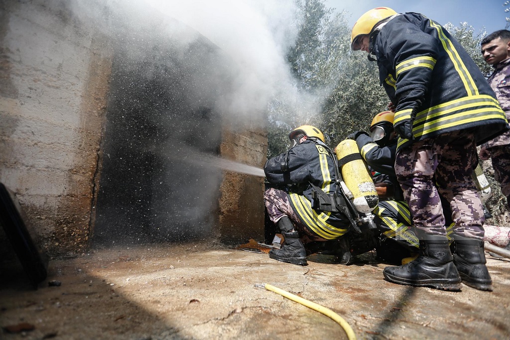 طواقم الدفاع المدني أثناء عملها على إخماد حريق أحد المنازل بهجوم للمستوطنين على بلدة ترمسعيا شمال رام الله (تصوير: محمد أبو زيد/وفا)